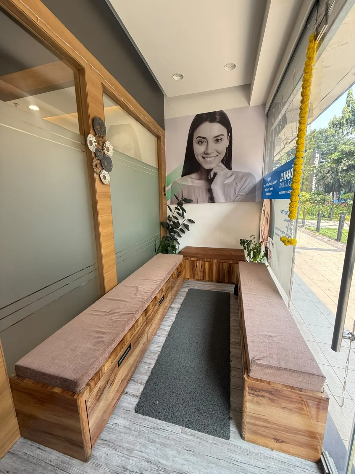 Wooden bench seating with cushions in the waiting area, beside the glass shopfront