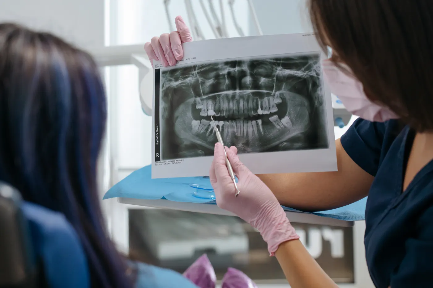 A dentist explaining an X-ray to a patient
